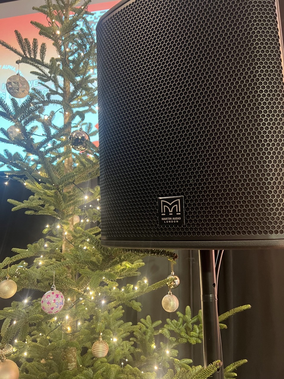speaker next to christmas tree